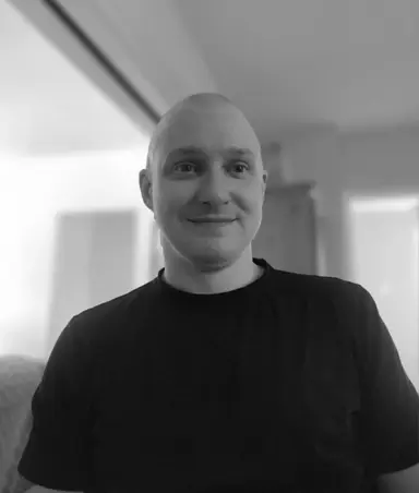 A black and white photo of Riley Hoffman in a black tshirt.